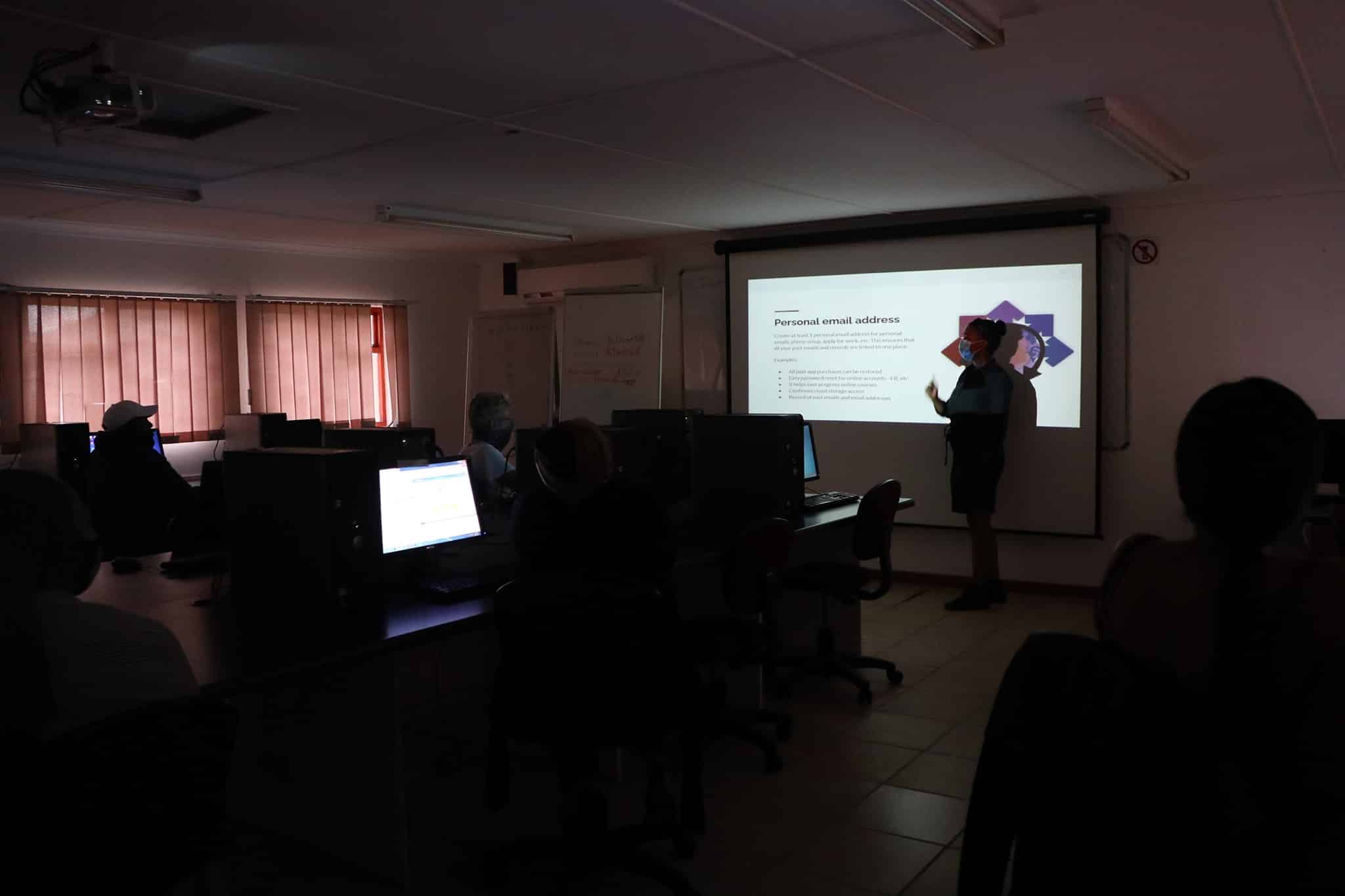 A wide view of the classroom environment equipped with desktop computers